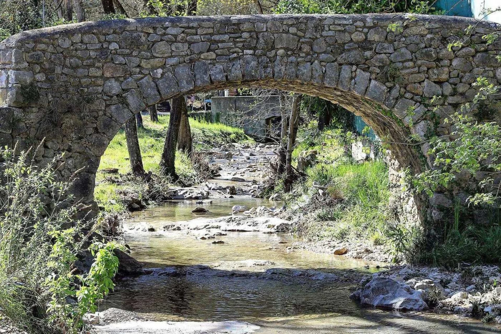 Old stone bridge over a stream near Roquefort-les-Pins