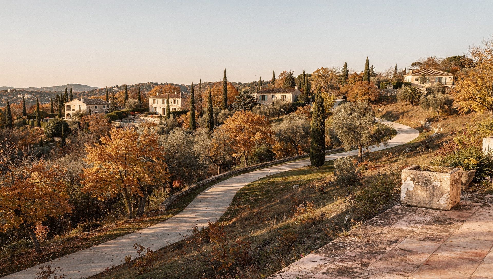 View from the village of Chateauneuf-de-Grasse over the Opio plain toward the Bay of Cannes and the Lerins islands at early morning, stone houses and olive terraces in the foreground