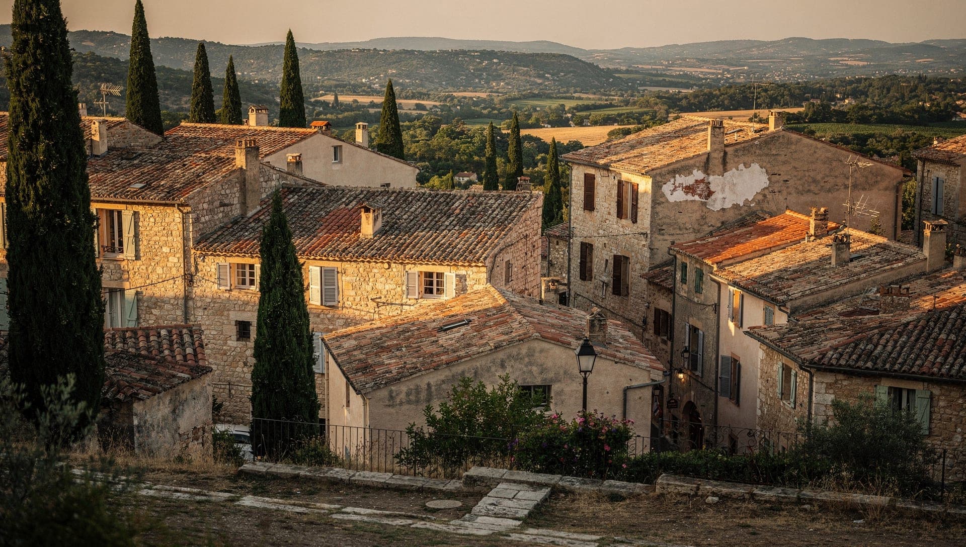View over the wooded hills and terracotta rooftops of Mougins above the Cannes hinterland at golden hour