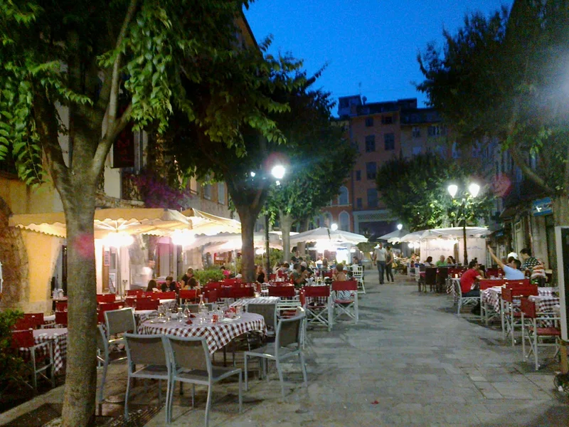 Evening dining on Place aux Aires in Grasse, Alpes-Maritimes, the old-town square where the Saturday market sets up under the plane trees